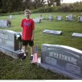 Dawson Bandy standing between graves of his grandmother, Sandra Bailiff Bandy, and great-great grandparents, George and Lovie Hale Barrett (Sycamore Cemetery, Cannon Co, TN)